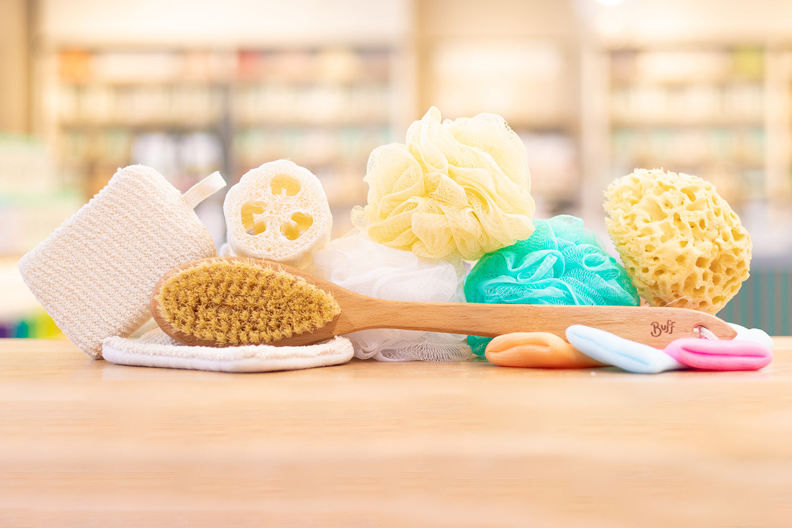 Sea sponge, soap sleeves, loofahs, and a body brush stacked on top of one another