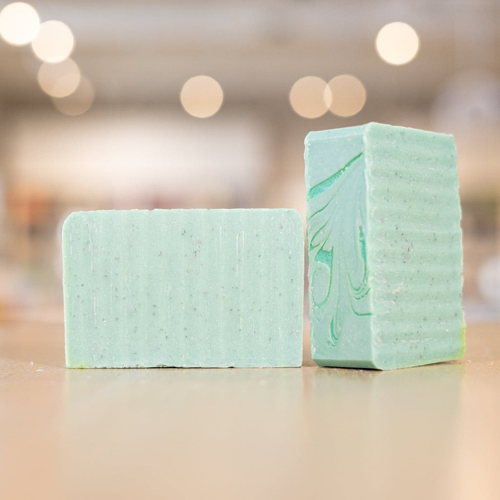 Two green Aloe Clover Soap Bars on counter 