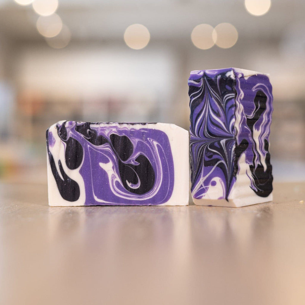 Two purple black and white soap bars 