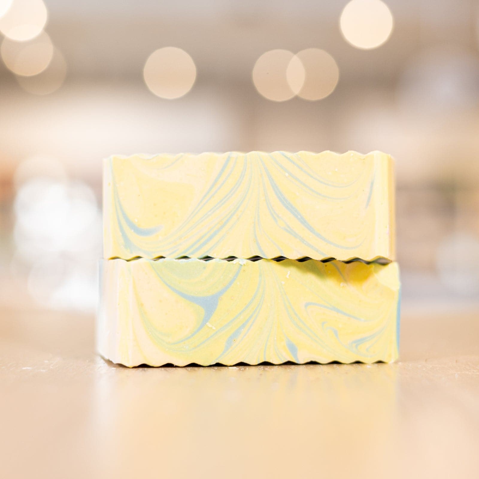 Two yellow Fresh Cotton Soap Bars with blue swirls stacked on counter