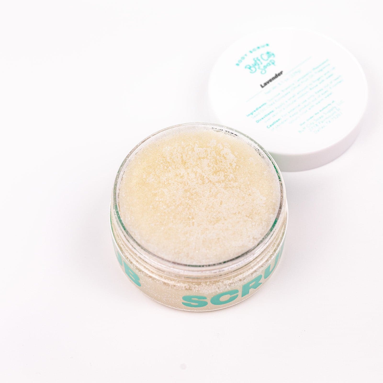 open Buff City Soap's lavender body scrub container with the white colored lid next to it