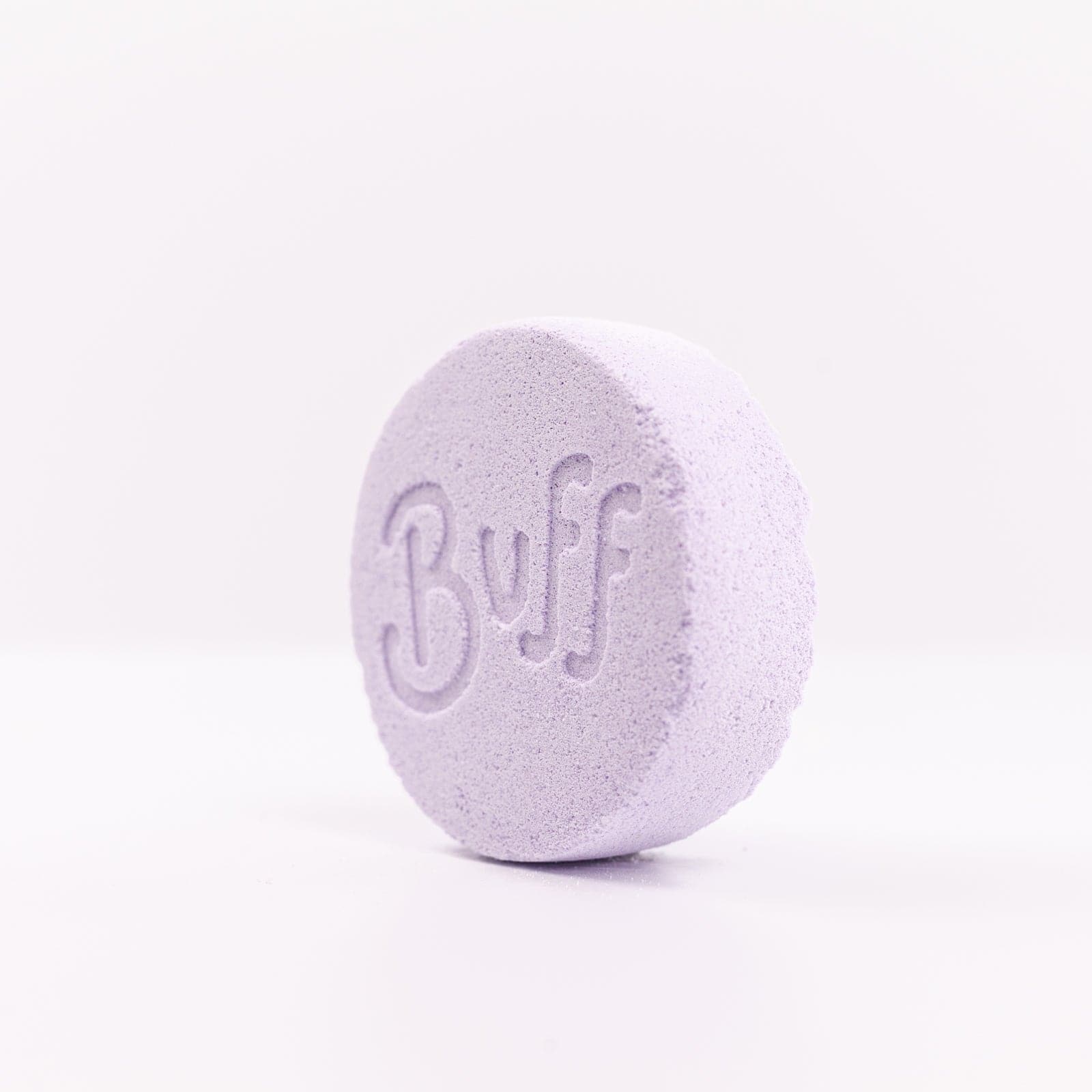 Buff City Soap's lavender colored and scented shower fizzy soap with buff written on its side