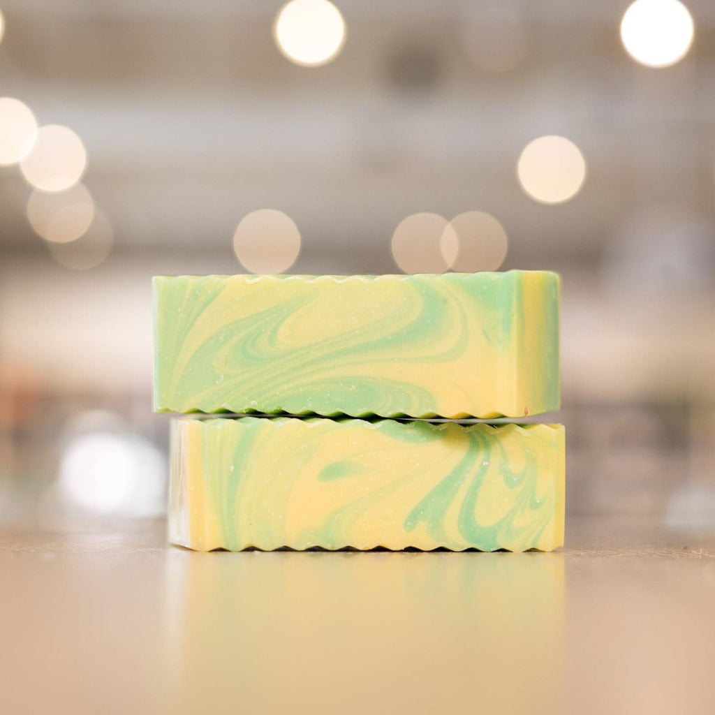 a stack of yellow and green colored Buff City Soap's lemongrass + eucalyptus soap