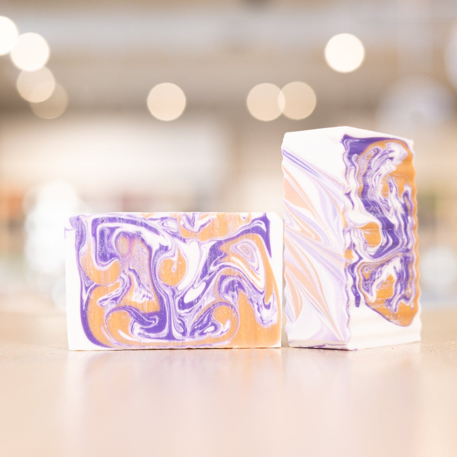 two Buff City Soap's multi-colored love potion soap bars