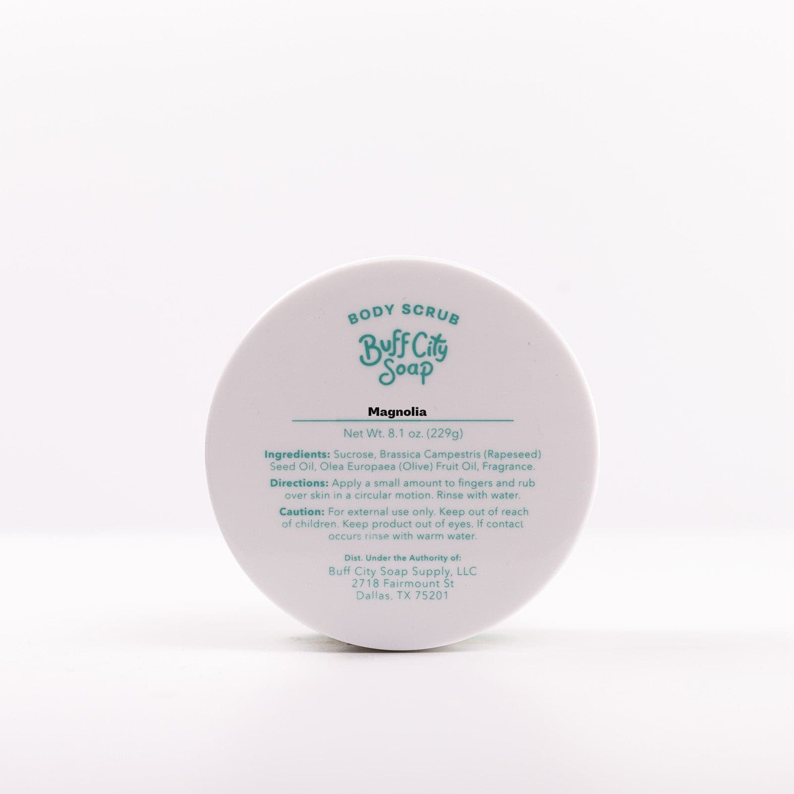 lid of Buff City Soap's magnolia scented body scrub listing the directions, ingredients and cautions