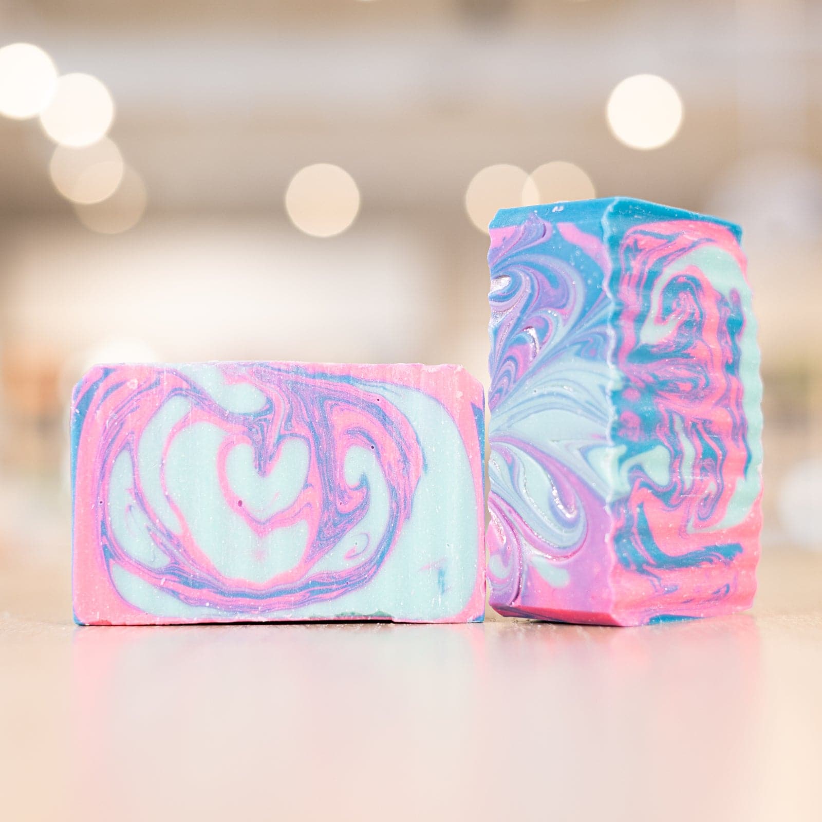 Two multi colored Mermaid Soap Bars on counter 