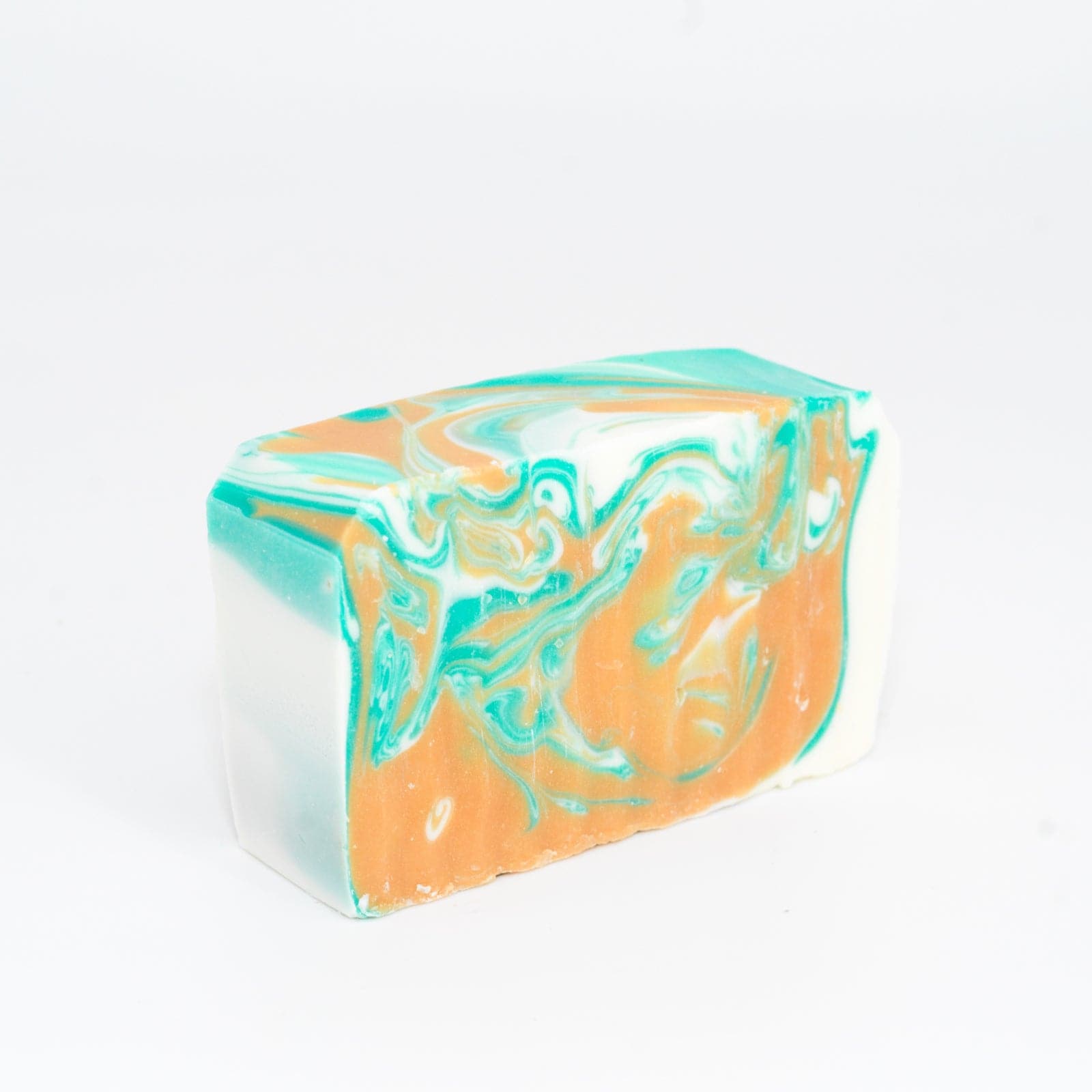 angled right view of a teal, orange, and white Narcissist Soap Bar