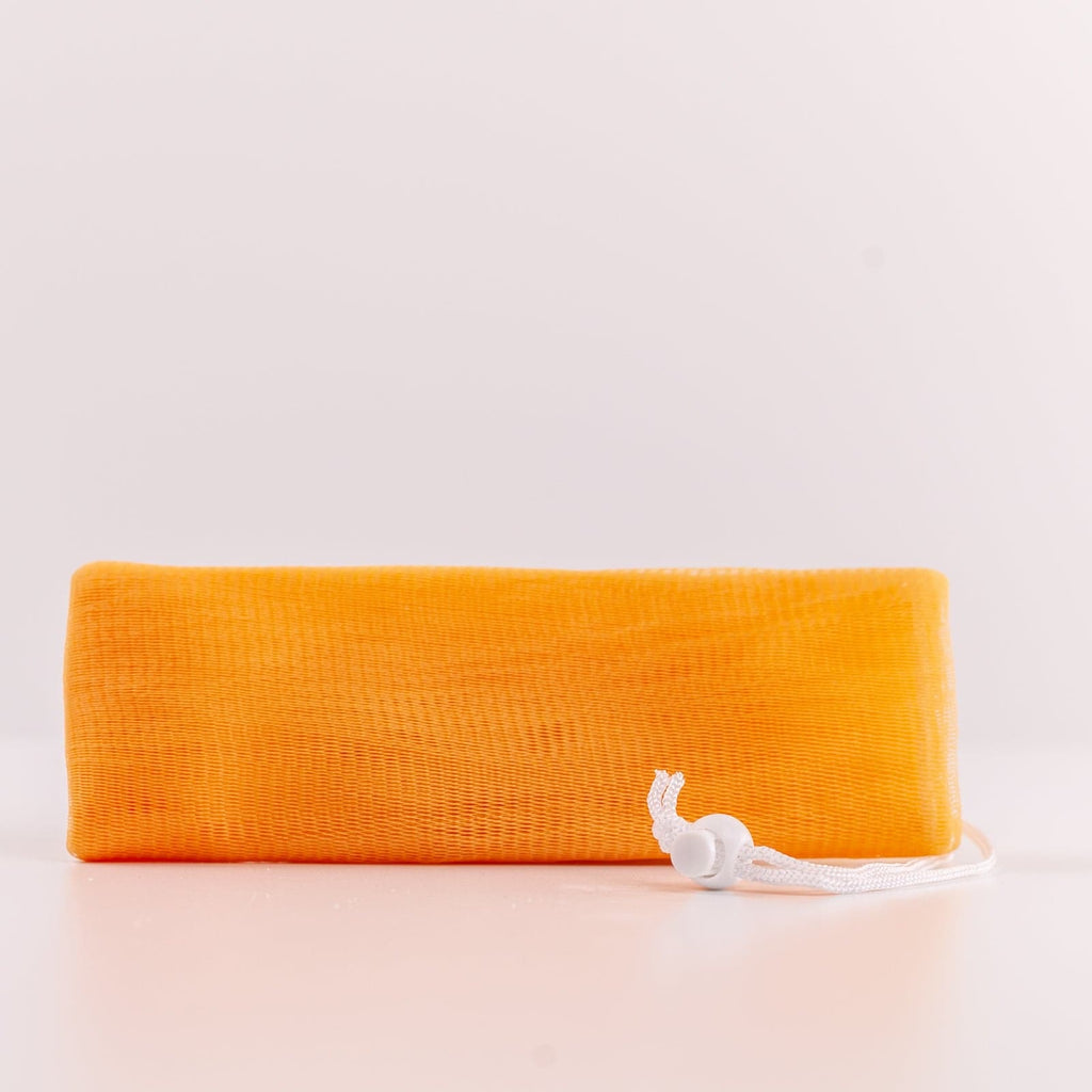 Orange Soap Sleeve with white drawstring against white background